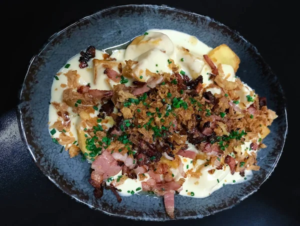 potatoes with ham, mayonnaise and toasted bacon