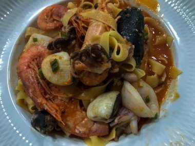 typical dish of italian cuisine, tagliatelle with seafood