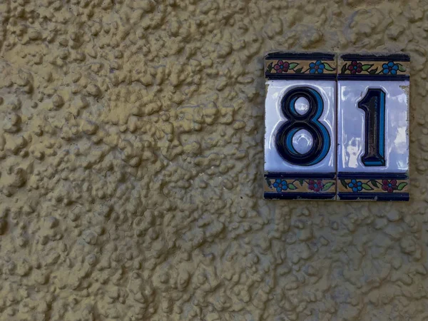 ceramic plaques placed on the wall with the number eighty-one