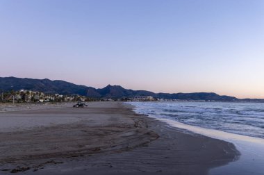 tractor working on the cleaning and maintenance of the beaches of the Mediterranean coast.