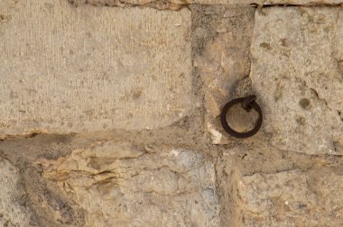 rusty metal ring anchored to a stone wall