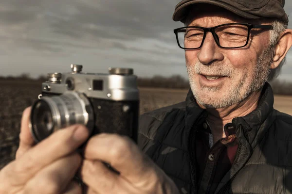 Портрет Пожилого Человека Аналоговой Камерой Записывающей Полевые Условия Зимой — стоковое фото