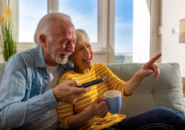 Senior Couple Watching Funny Scenes Movie Laughing Sofa Home Mature — Stock Photo, Image