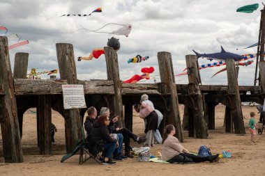 St Annes Lancashire United Kingdom August 30th 2025 St Annes Kite Festival Attendees prepare kites for flight at the annual festival