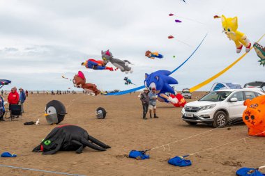 St Annes Lancashire United Kingdom August 30th 2025 St Annes Kite Festival Attendees prepare kites for flight at the annual festival