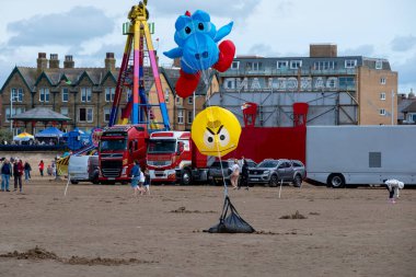 St Annes Lancashire United Kingdom August 30th 2025 St Annes Kite Festival Attendees prepare kites for flight at the annual festival