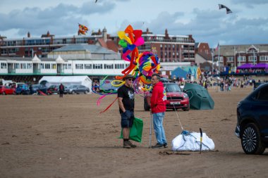 St Annes Lancashire United Kingdom August 30th 2025 St Annes Kite Festival Attendees prepare kites for flight at the annual festival