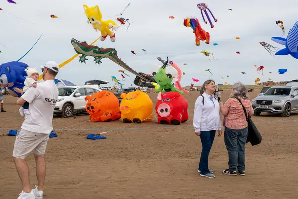 St Annes Lancashire United Kingdom August 30th 2025 St Annes Kite Festival Attendees prepare kites for flight at the annual festival