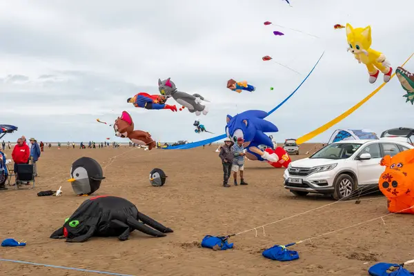 St Annes Lancashire United Kingdom August 30th 2025 St Annes Kite Festival Attendees prepare kites for flight at the annual festival