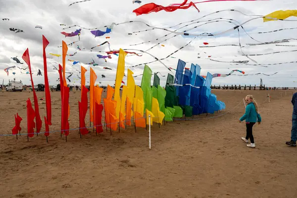 St Annes Lancashire United Kingdom August 30th 2025 St Annes Kite Festival Attendees prepare kites for flight at the annual festival