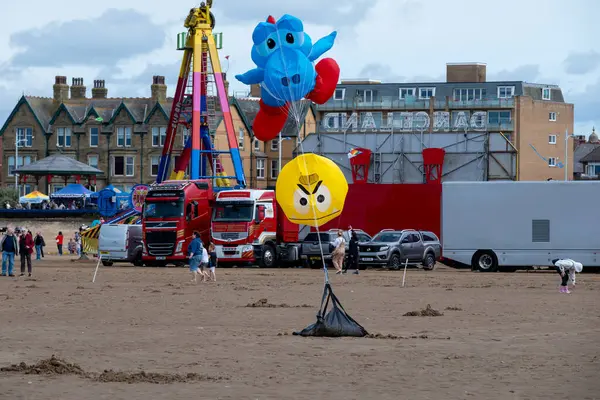 St Annes Lancashire United Kingdom August 30th 2025 St Annes Kite Festival Attendees prepare kites for flight at the annual festival