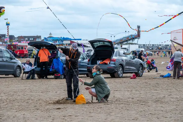 St Annes Lancashire United Kingdom August 30th 2025 St Annes Kite Festival Attendees prepare kites for flight at the annual festival