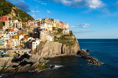 Günbatımında Cinque Terre 'de Manarola' nın güzel manzarası, Akdeniz 'in yukarısındaki kayalıklarda renkli evler..