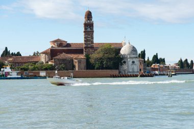 Venedik, İtalya-25 Nisan 2024: Venedik, İtalya 'daki San Michele Adası' nda sürat teknesi süzülerek tarihi kilise ve deniz manzarasını gözler önüne serdi..