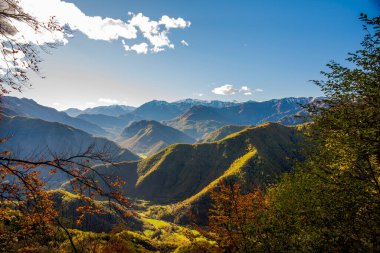 autumn panorama between the valleys and mountain peaks in the Vicenza pre-Alps among the autumnal woods of Arsiero Vicenza Italy clipart