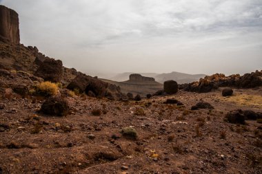 panorama of the Moroccan Atlas mountain peaks with desert valleys and orange rocks among the Berber trails in Jebel Saghro near Ouarzazate Marrakech in Morocco clipart