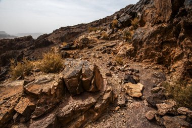 close up of rocks and rock formations among the peaks of the Moroccan Atlas between desert valleys and Berber lands in Jebel Saghro near Ouarzazate in Marrakech Morocco clipart