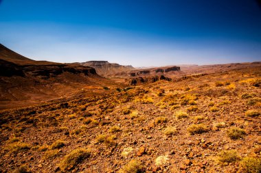 Marakeş yakınlarındaki Bab N Ali ve Jebel Saghro ile Fas 'taki Ouarzazate arasındaki atlas üzerindeki güney atlas Fas' ın tepeleri ve kayalıkları volkanik dağlardan, ovalardan ve platolardan oluşan bir panorama.