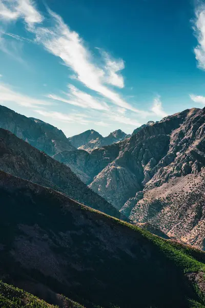 stock image The majestic Atlas Mountains in Morocco. Mountain peaks and rugged terrain under a clear blue sky create a breathtaking, dramatic landscape.