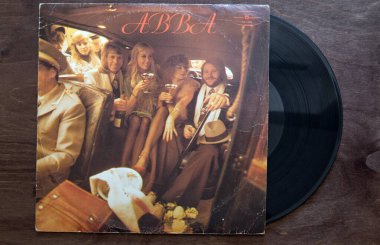 Lublin, Poland. 18 January 2023. Abba vinyl album cover on dark wooden table