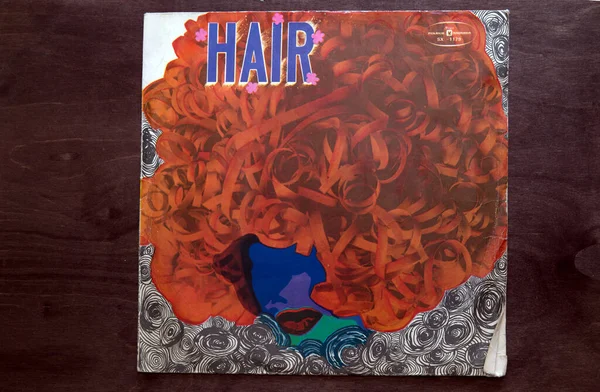 Lublin, Poland. 18 January 2023.Hair music hall soundtrack long play on dark wooden table