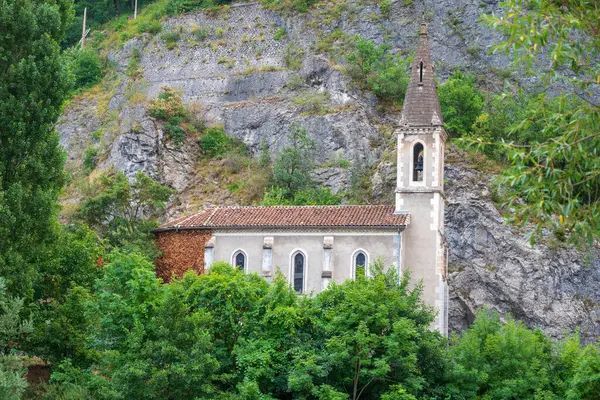 Stock image Pontaix, France August 15 2024 old narrow church built between a mountain and a river