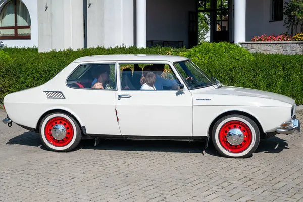 stock image Lublin, Poland August 24 2024 classic saab 99 beige car with red wheel in the street