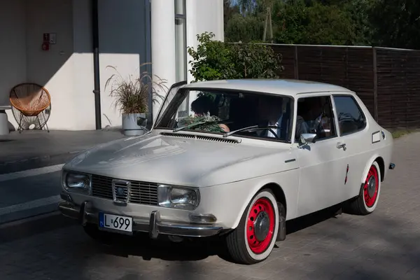 stock image Lublin, Poland August 24 2024 classic saab 99 beige car with red wheel in the street