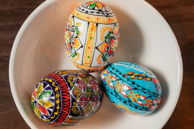 Üç geleneksel renkli paskalya yumurtası kasede.