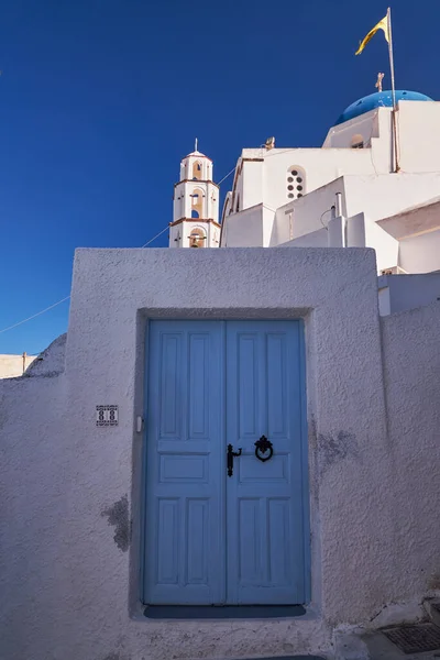 The Church of Christ - Blue Dome and Bell Tower - Blue Wooden Door on a Tradional Greek Whitewash House - Pyrgos Village, Santorini Island, Greece