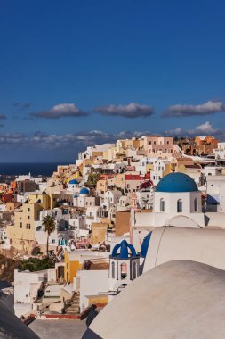 Yunanistan 'ın Santorini Adası' ndaki Oia Köyü ve Mavi Kubbe Kilisesi 'nin Panoramik Hava Görüntüsü - Caldera Kayalıklarındaki Geleneksel Beyaz Evler - Günbatımı