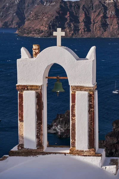 White Church with Bell Tower in Oia Village, Caldera View - Santorini Island, Greece