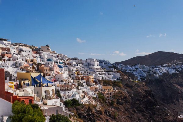 Panoramic Aerial View of the Poscard Perfect Oia Village in Santorini Island, Greece - Traditional White Houses in the Caldera Cliffs - Sunset