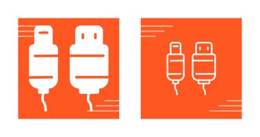 Turuncu arkaplanda duran iki usb kablosu