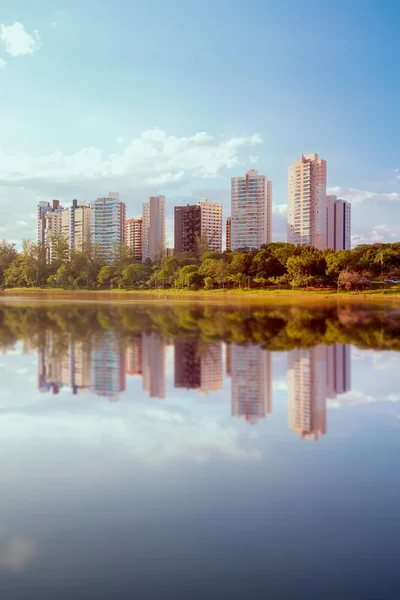 View of Igap Lake in the city of Londrina, Brazil. Afternoon sun light. Buildings in the background.