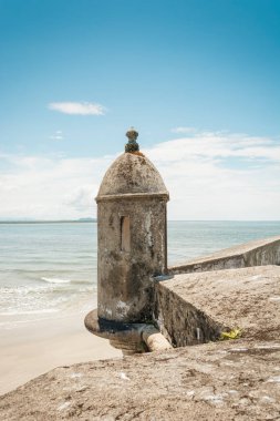 An ancient fortress by the beach. Built in a time long gone by, stands tall and proud on the edge of the beach.