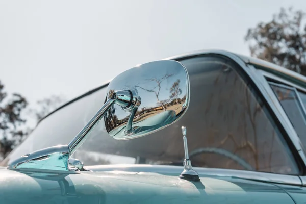 Car rear view mirror of an antique vehicle. Classic vintage style.