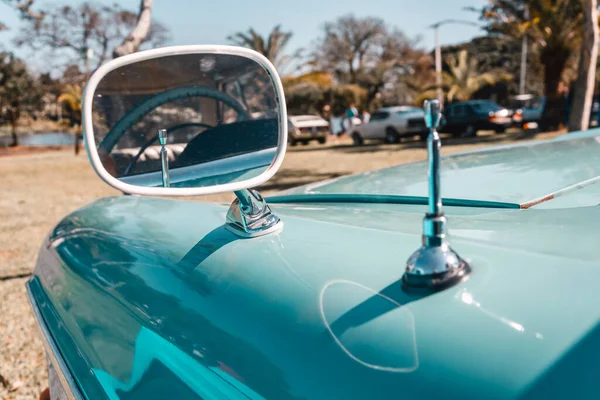Car rear view mirror of an antique vehicle. Classic vintage style.