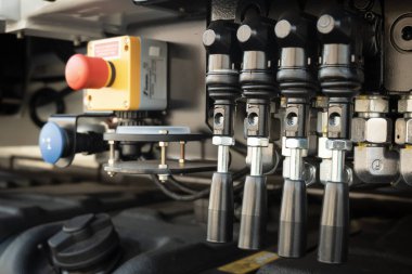 Detail of a hydraulic control mechanism of a concrete pump truck.