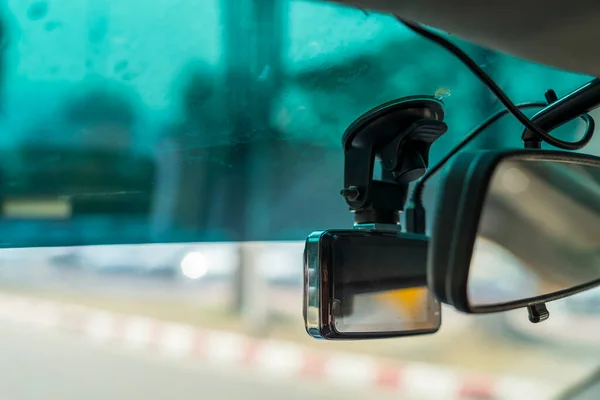 video recorder next to a rear view mirror, CCTV car camera for safety on the road accident