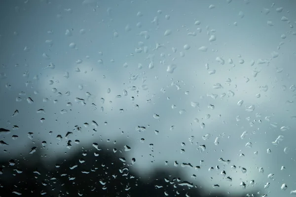 Raindrops on glass walls on cars, rain drops on clear windows or rain droplets on glass of raindrops or vapors of windows