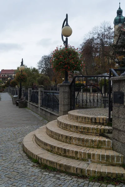 stone stairs to the bridge crossing the river view of the pedestrian zone in Polanica Zdrj Poland photo in autumn