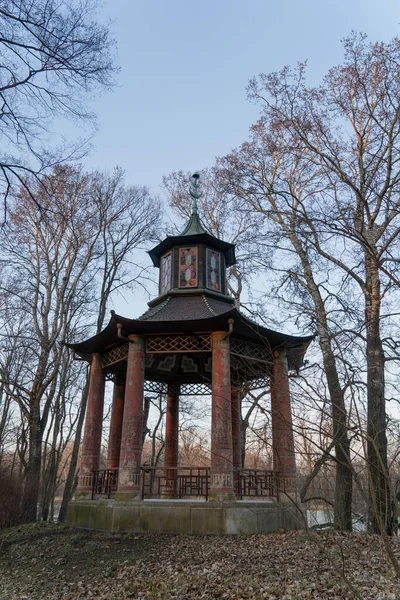 stock image gazebo with concrete columns in Chinese style with stained glass windows in the park in early spring