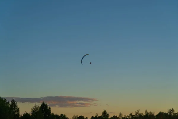 paragliding silhouette of a paraglider in the air against the background of the evening sky at sunset