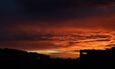 beautiful red orange sunset with silhouette of houses