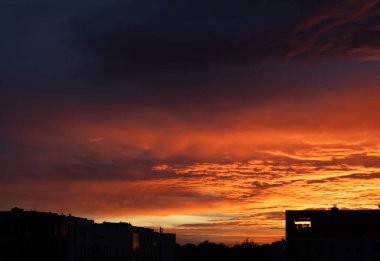 beautiful red orange sunset with silhouette of houses