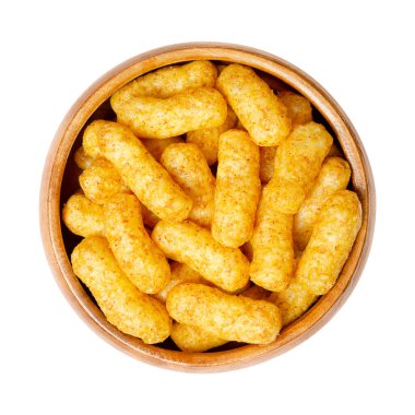 Peanut flips, in a wooden bowl. Also known as Bamba, peanut puffs or snips, is a puffed, peanut-flavored corn snack, with a peanut content up to a third. Close-up, from above, isolated, macro photo. clipart