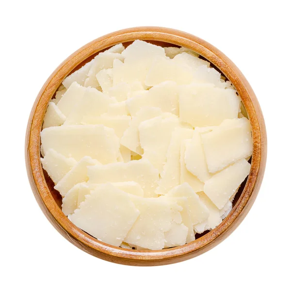 グラナパダーノチーズフレーク 木製のボウルに イタリアのハードチーズ パルメザンチーズに似て ザクザクとした食感 強い風味とややコクのあるテクスチャ 低温殺菌されていない牛乳から作られています — ストック写真