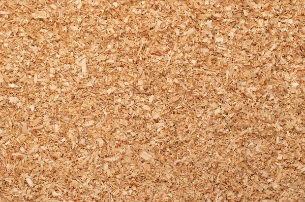 Coarse sawdust, wood chips, small chippings of wood, formed by sawing dried spruce. By-product and waste product, mainly used as additive for chipboards and wood pulp. Surface, background, from above.