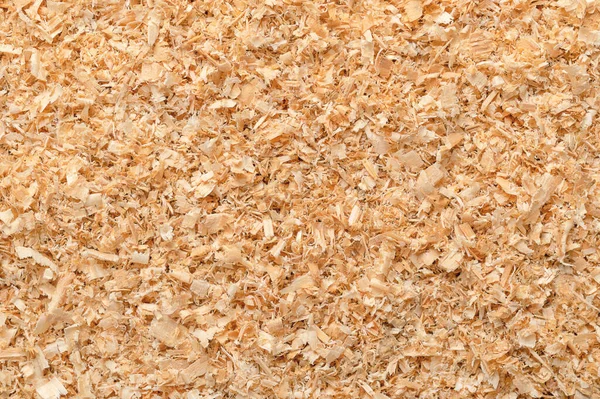Wood chips, coarse sawdust, close-up, surface from above. Small chippings of wood, formed by sawing dried spruce. By-product and waste product, mainly used as additive for chipboards and wood pulp.
